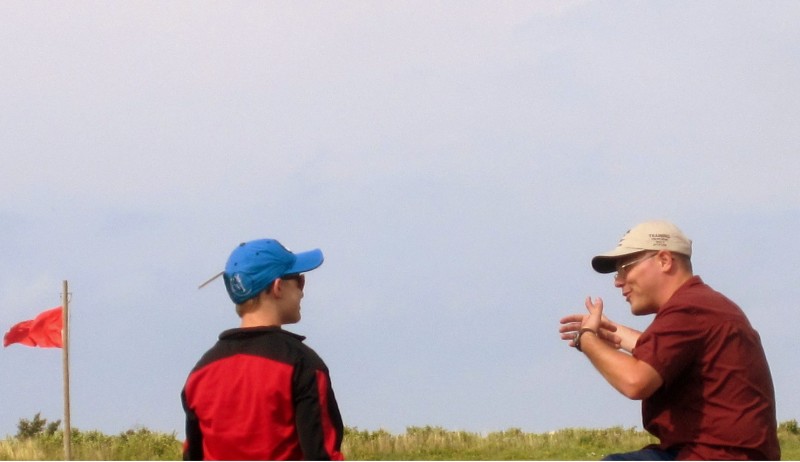 One of our coaches works with a youth shooter at the CMP Small Arms Firing School at Camp Perry.